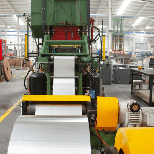 Industrial steel coil machine, stainless steel being processed on heavy machinery