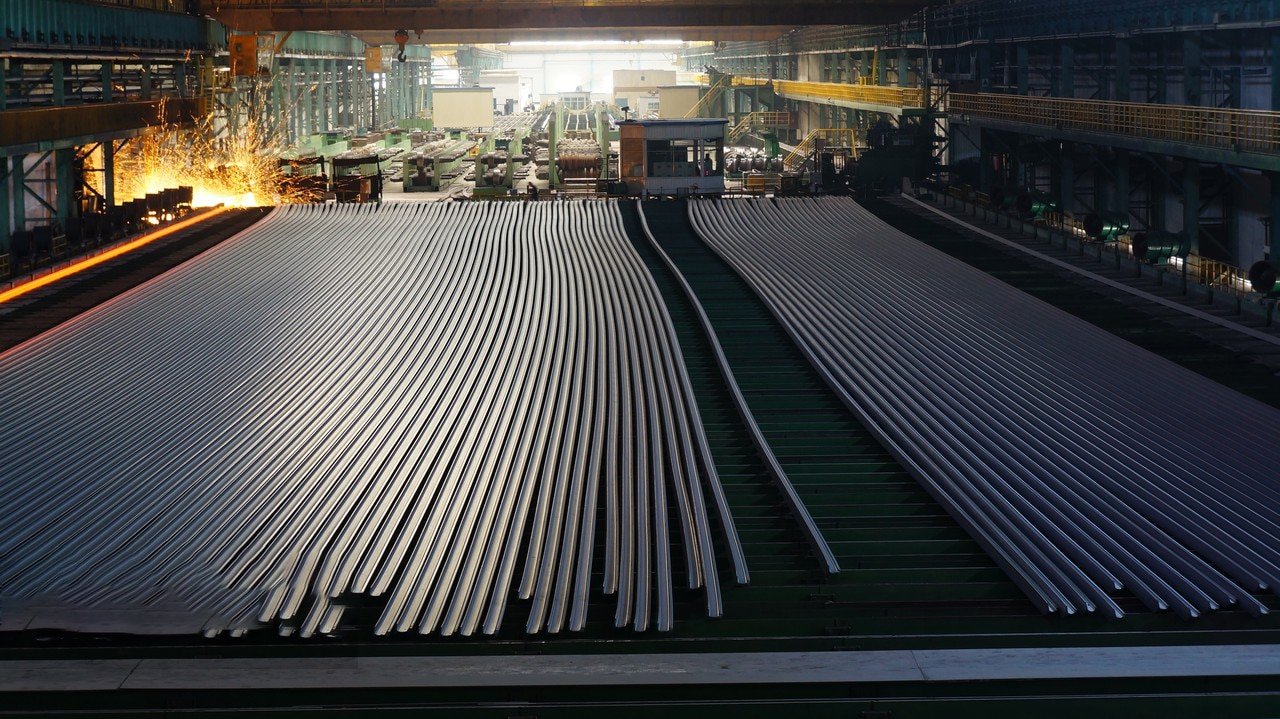 Steel sheet production machine, workers inspecting equipment