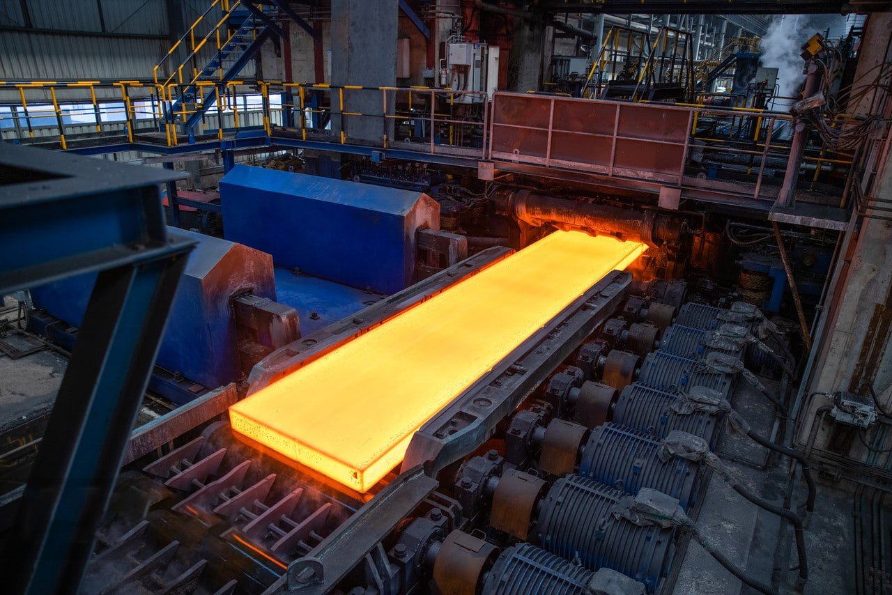 Steel factory interior with heavy machinery, manufacturing process