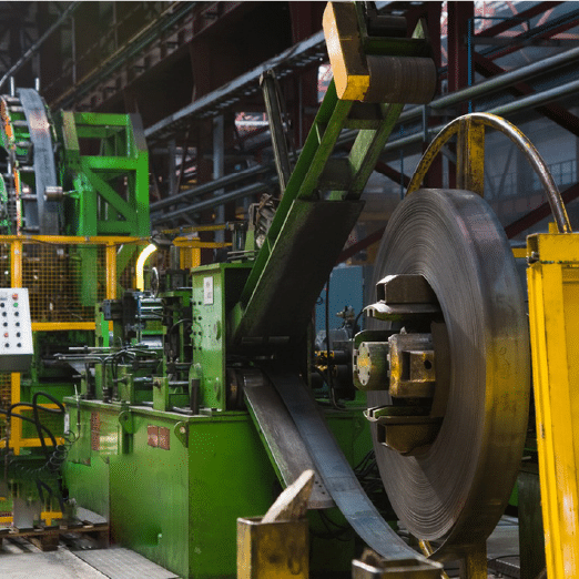 Sheet metal coiling and processing equipment in a factory.