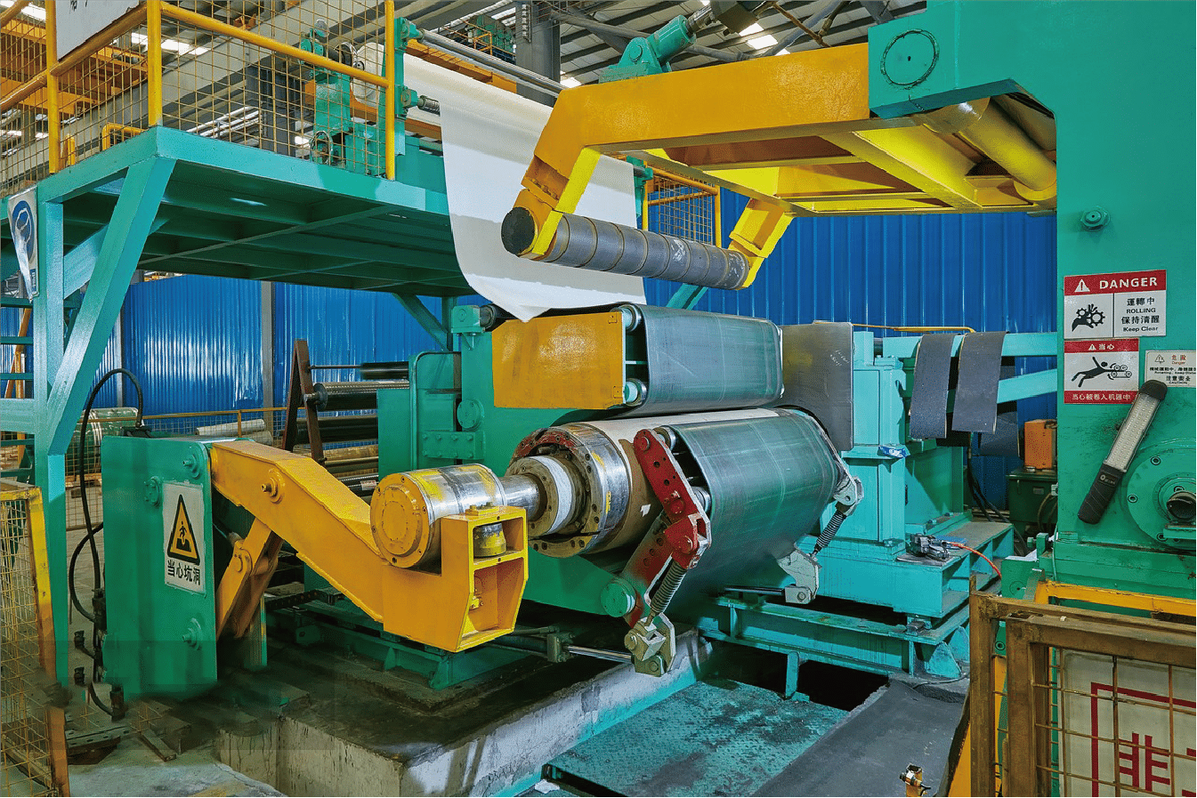 Industrial stainless steel rolling machine in operation