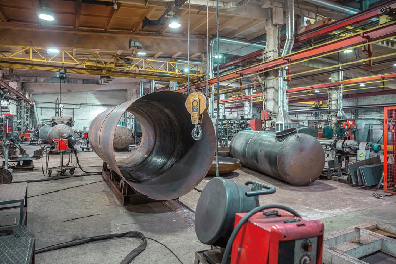 Operators working around precision stainless steel cold rolling line for high-strength material processing