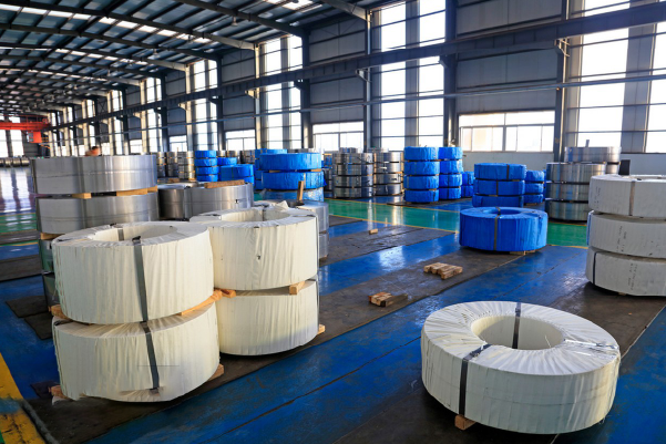 Stainless steel coils stored in industrial warehouse, ideal for B2B supply chain and manufacturing needs