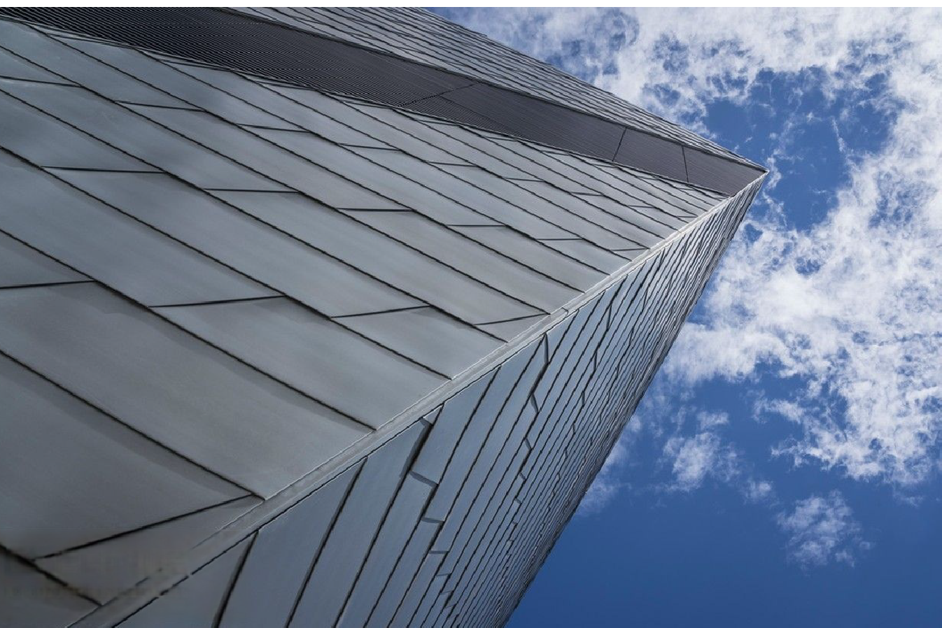 Modern skyscrapers with stainless steel and glass facade, showcasing MFY's role in construction-grade material supply