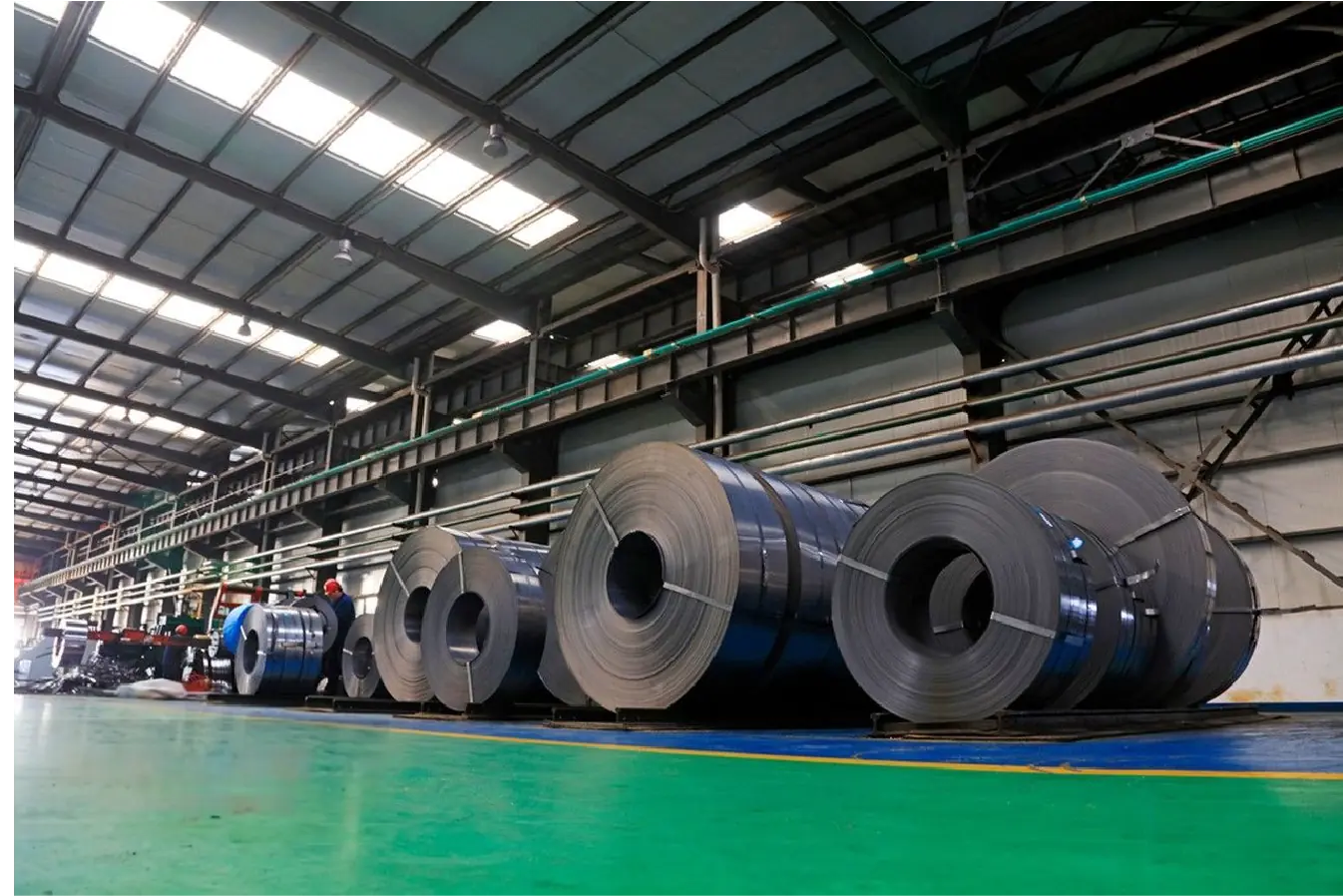Warehouse showcasing MFY's stainless steel coils ready for export with vibrant lighting.