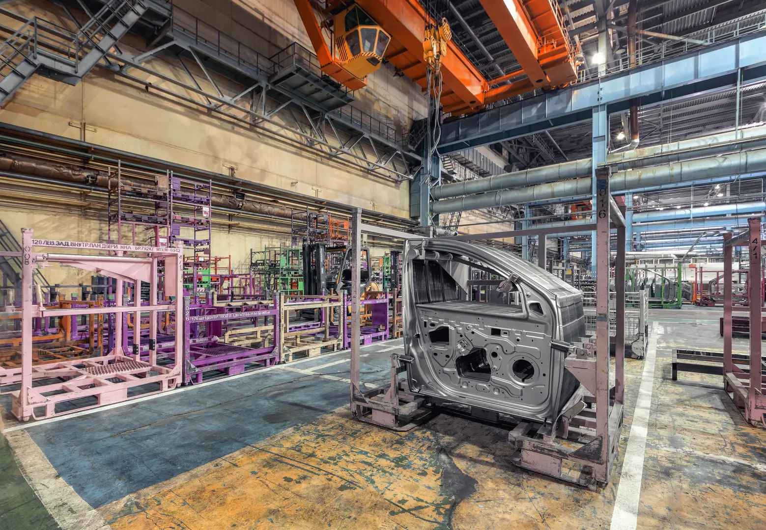Interior view of a steel manufacturing facility with machinery and metal components.
